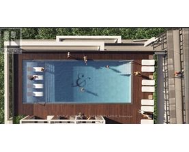 A large outdoor swimming pool with a wooden deck and lounge chairs.