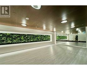 A spacious room with a green wall and wooden flooring.