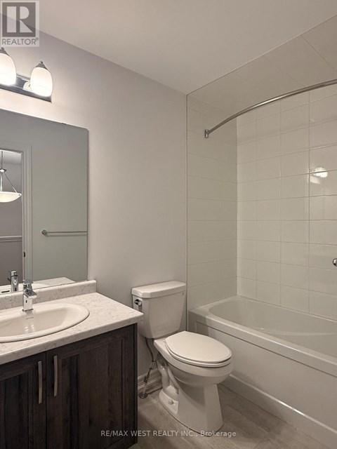 A white toilet sits next to a sink in a bathroom.