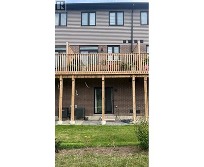 A house with a wooden deck in front.