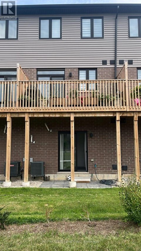 A house with a wooden deck in front.