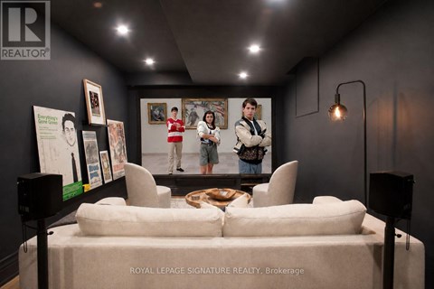 A brokerage office with a white couch and a poster on the wall.