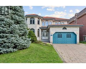 A house with a blue garage door is for sale.