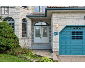 A house with a blue door and a sign that says 185.