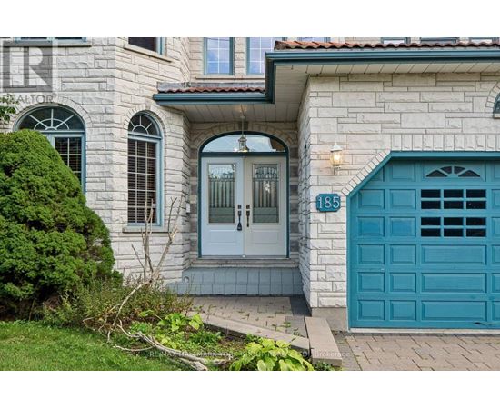 A house with a blue door and a sign that says 185.