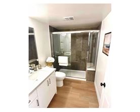 A bathroom with a walk in shower and a toilet.