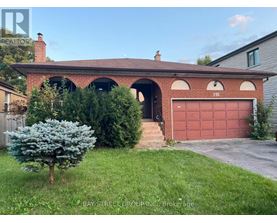 A red brick house with a garage door numbered 191.