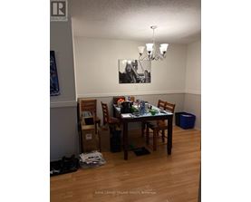 A dining room with a table set for four.