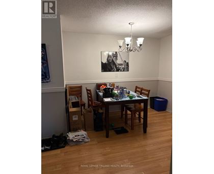 A dining room with a table set for four.