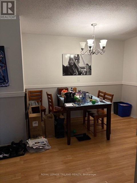 A dining room with a table set for four.
