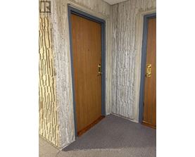 A room with two doors, one of which is closed.