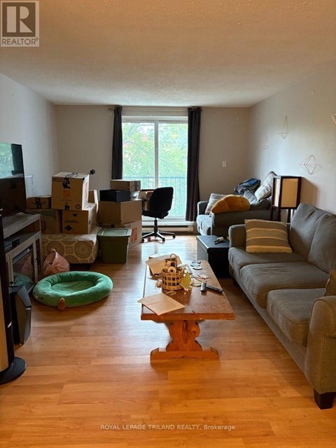 A living room with a grey couch and a wooden coffee table.