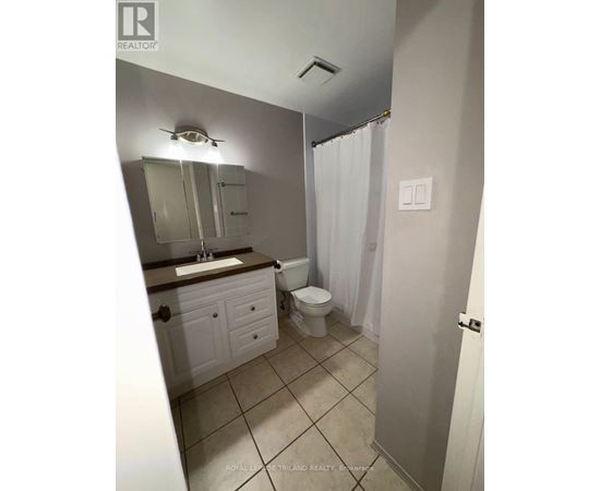 A kitchen with a white fridge and a white ceiling fan.