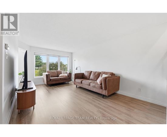 A living room with a brown sofa and a television.