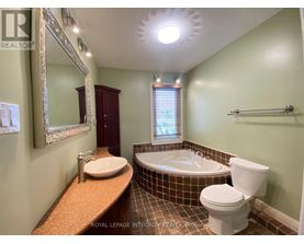 A bathroom with a toilet, sink, and bathtub.
