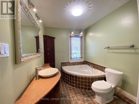 A bathroom with a toilet, sink, and bathtub.