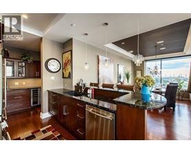 A modern kitchen with dark wood cabinets and a large island.
