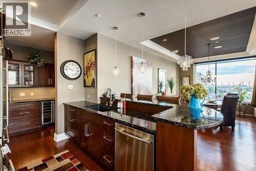 A modern kitchen with dark wood cabinets and a large island.