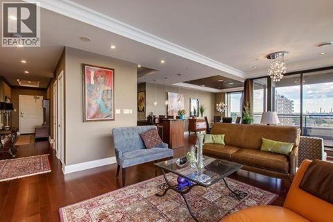 A living room with a blue couch and a brown couch.
