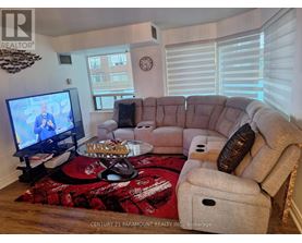 A living room with a couch, a coffee table, and a television.