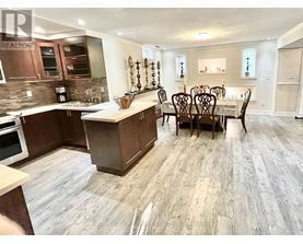 A kitchen with a dining table and chairs.