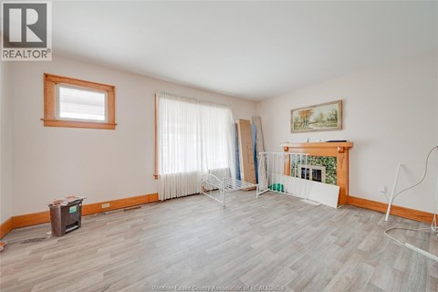 A room with a fireplace and a painting on the wall.