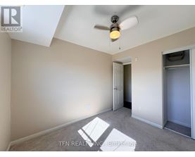 A room with a ceiling fan and a light fixture.