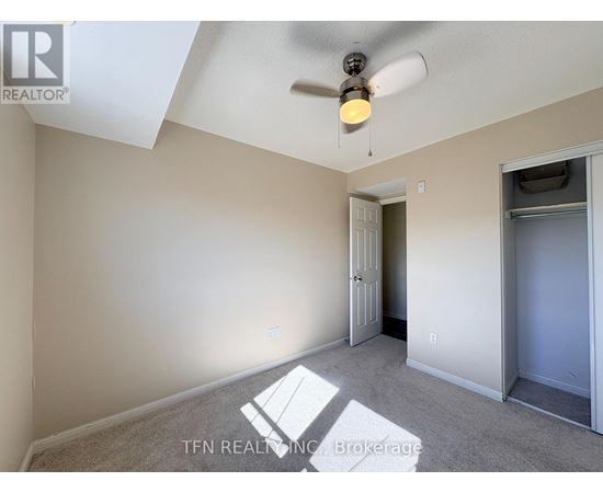 A room with a ceiling fan and a light fixture.