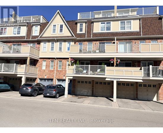 A building with balconies and garages in front of it.