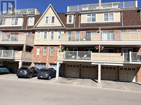 A building with balconies and garages in front of it.