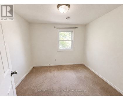 A room with a window and carpeted floor.