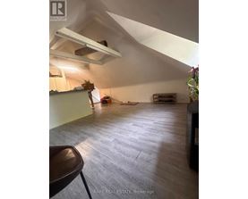 A room with a high ceiling and a wooden floor.