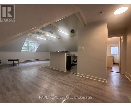 A room with a high ceiling and a wooden floor.