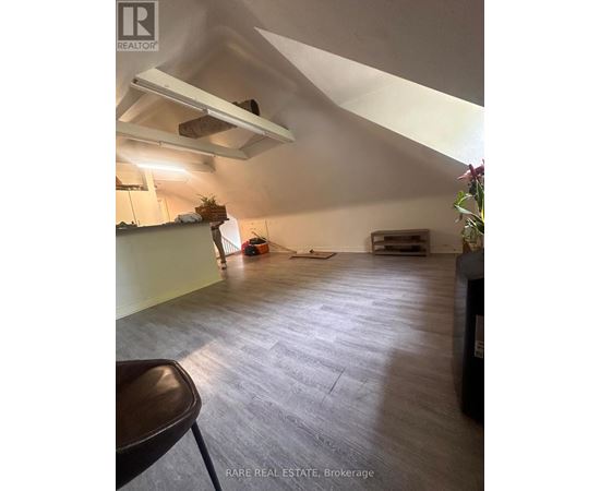 A room with a high ceiling and a wooden floor.