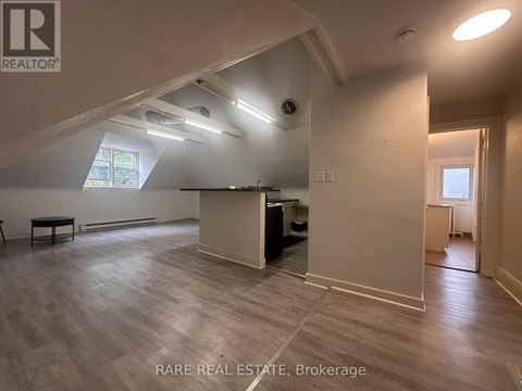 A room with a high ceiling and a wooden floor.