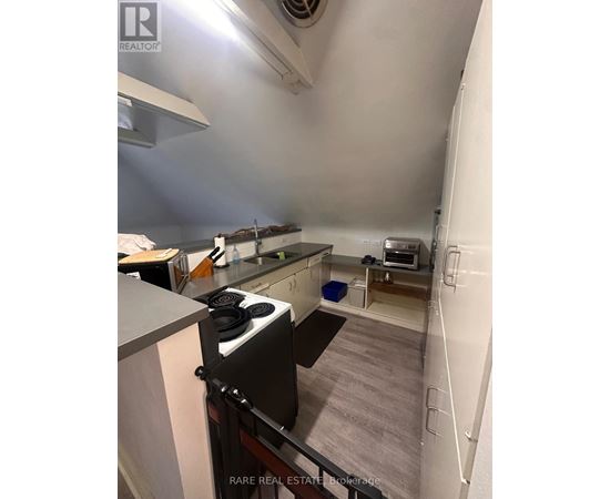 A small kitchen with a stove and a microwave.