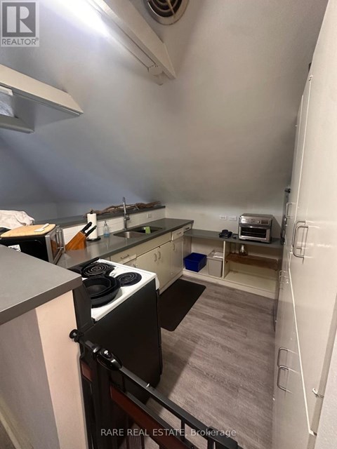 A small kitchen with a stove and a microwave.