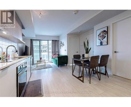 A modern kitchen with a dining table set for four.