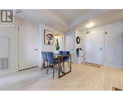 A dining room with a table and chairs.