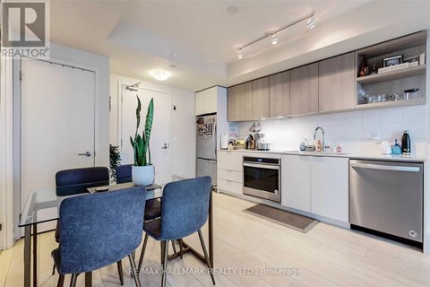 A modern kitchen with a dining table and chairs.
