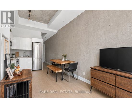 A modern kitchen with a wooden table and chairs.