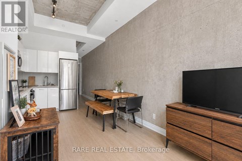 A modern kitchen with a wooden table and chairs.