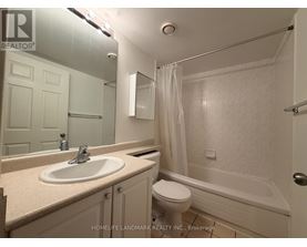 A bathroom with a sink, toilet and bathtub.