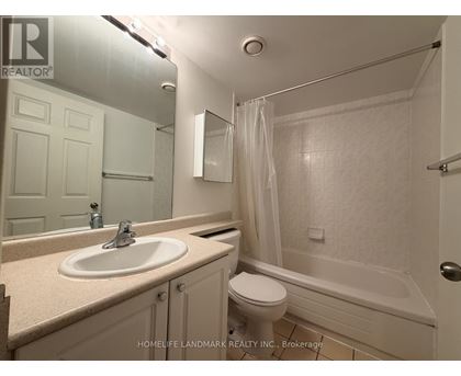 A bathroom with a sink, toilet and bathtub.