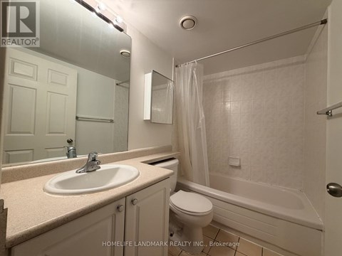 A bathroom with a sink, toilet and bathtub.