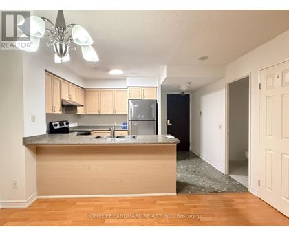 A kitchen with wooden cabinets and a granite countertop.
