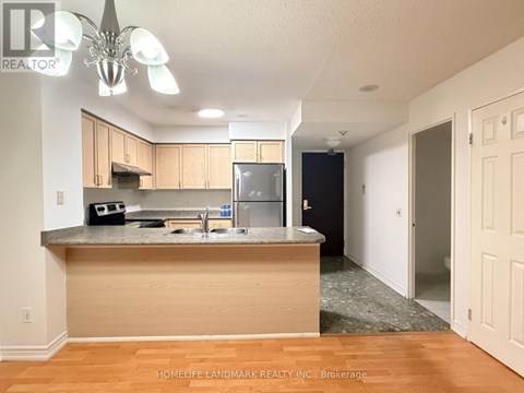 A kitchen with wooden cabinets and a granite countertop.