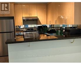 A kitchen with a countertop that has a brokerage sign on it.