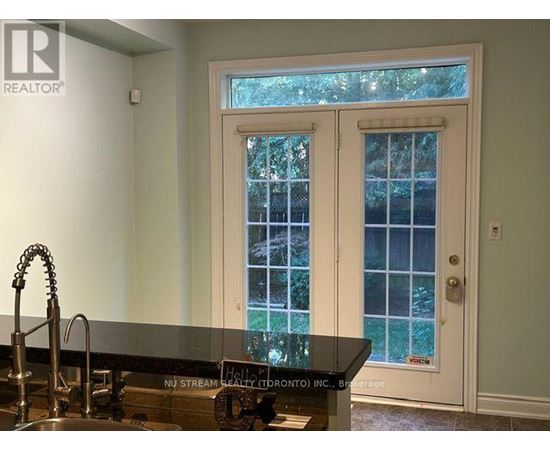 A kitchen with a sink and a window.