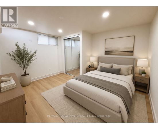 A bedroom with a large bed, a nightstand, and a plant.